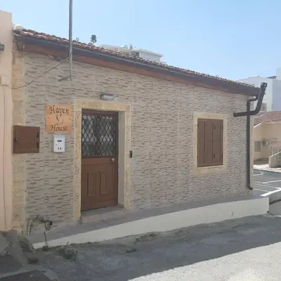 a brick building with a door and a sign on it at HAVEN HOUSE in Larnaka