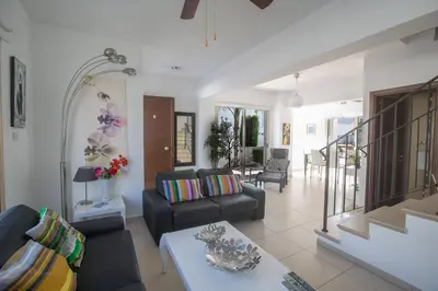 a living room with a couch and a table at Palm Villa 17 in Protaras