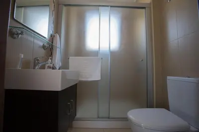 a bathroom with a shower with a sink and a toilet at Palm Villa 17 in Protaras
