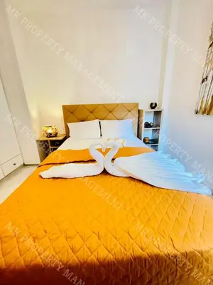 a bed with two white towels on top of it at Milos City Center Apt. 32 in Larnaka