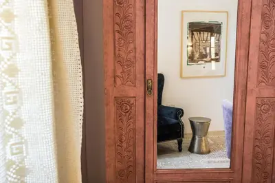 a wooden door with a mirror in a room at myLofou in Lofou