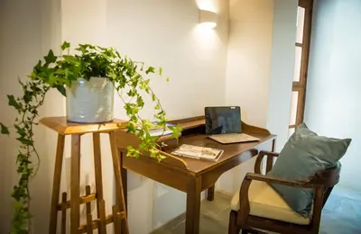 a desk with a chair and a plant on it at myLofou in Lofou