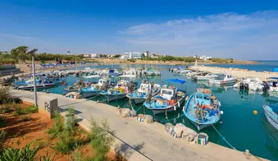 a bunch of boats are docked in a harbor at By The Beach - Royal Sapphire Villa in Protaras