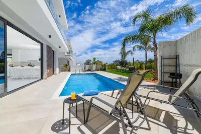 a villa with a swimming pool and a patio at By The Beach - Royal Sapphire Villa in Protaras