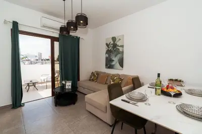 a living room with a couch and a table at SerenityOne - Centrally located One Bedroom Apt in Ayia Napa