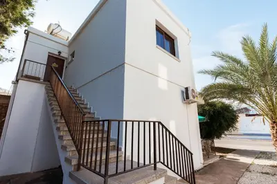 a staircase leading up to a house with the beach at SerenityOne - Centrally located One Bedroom Apt in Ayia Napa