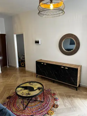 a living room with a table and a mirror at Ayia napa rest in Ayia Napa