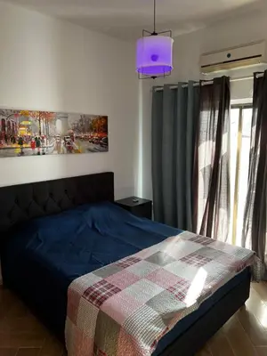 a bedroom with a bed with a blue comforter at Ayia napa rest in Ayia Napa