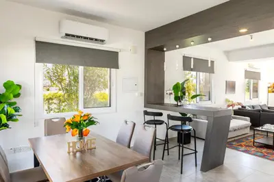 a kitchen and living room with a table and chairs at Napa Bay View Villa in Ayia Napa