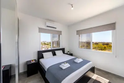 a bedroom with a bed with two towels on it at Napa Bay View Villa in Ayia Napa