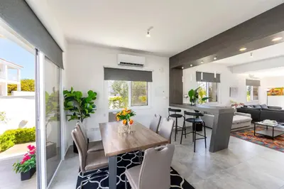 a kitchen and living room with a table and chairs at Napa Bay View Villa in Ayia Napa