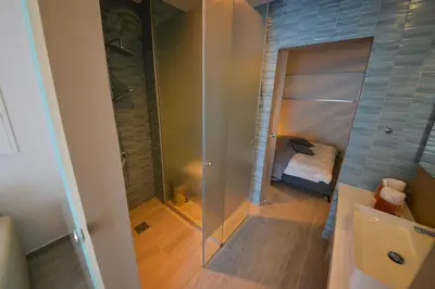 a bathroom with a shower and a glass shower stall at De Lux Mythical SPA 9 in Paralimni