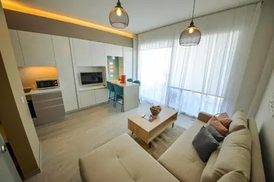a living room with a couch and a table at De Lux Mythical SPA 9 in Paralimni