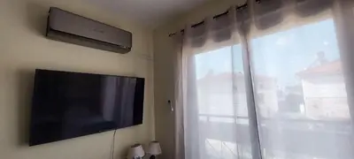 a flat screen tv on a wall next to a window at Anna-Maria 3 bedroom villa in Paralimni