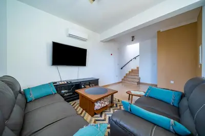a living room with a couch and a flat screen tv at Anna-Maria 3 bedroom villa in Paralimni