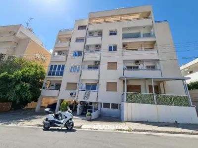 a motorcycle parked in front of a building at Springfield Park Apartment in Larnaka