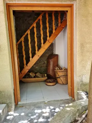 a wooden staircase in a room with two baskets at Elpiniki's Old House in Kalopanayiotis