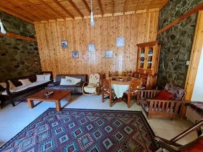 a living room with a couch and a table at Elpiniki's Old House in Kalopanayiotis
