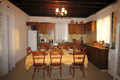a kitchen with a table and chairs in it at House of Roses in Limassol