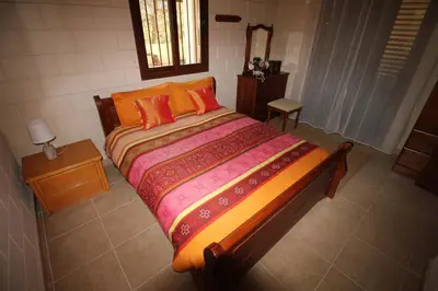 a bedroom with a large bed with orange pillows at House of Roses in Limassol