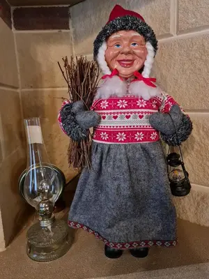 a figurine of a woman in a dress standing next to a lamp at House of Roses in Limassol