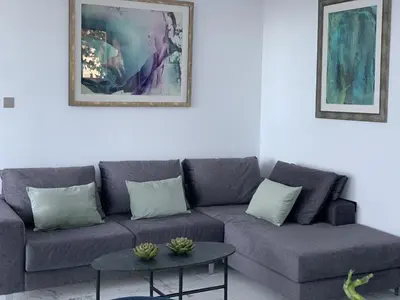 a living room with a couch and a table at The Address-Seafront Luxury 2 Bedroom Residence in Limassol