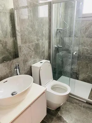 a bathroom with a toilet and a sink and a shower at The Address-Seafront Luxury 2 Bedroom Residence in Limassol