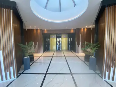 a hallway of a building with two potted plants at The Address-Seafront Luxury 2 Bedroom Residence in Limassol