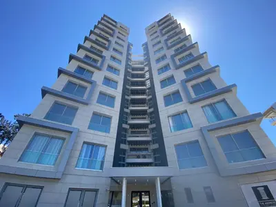 two tall apartment buildings against a blue sky at The Address-Seafront Luxury 2 Bedroom Residence in Limassol