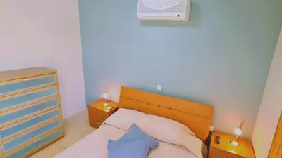a bedroom with a bed with two night stands and two lamps at STAY Kapparis Horizon in Paralimni