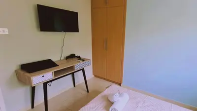 a room with a desk with a television on a wall at STAY Kapparis Horizon in Paralimni
