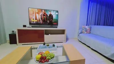 a living room with a tv and a bowl of fruit at STAY Kapparis Horizon in Paralimni