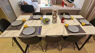 a table with chairs and plates and drinks on it at STAY Kapparis Horizon in Paralimni
