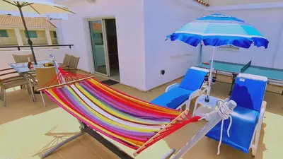 a hammock and an umbrella in a living room at STAY Kapparis Horizon in Paralimni
