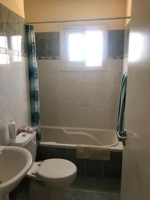 a bathroom with a toilet and a tub and a sink at Paralimni in Paralimni