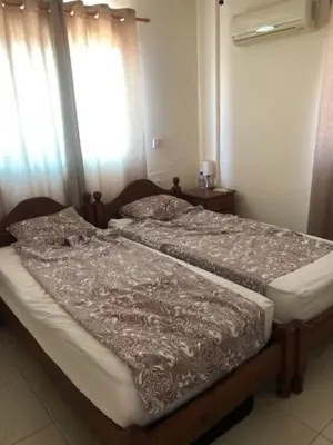 two twin beds in a room with a window at Paralimni in Paralimni