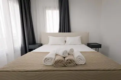 a bed with three towels on top of it at Mediterranean Dream Beachfront Villa in Larnaka