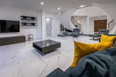a living room with a couch and a tv and a table at Mediterranean Dream Beachfront Villa in Larnaka