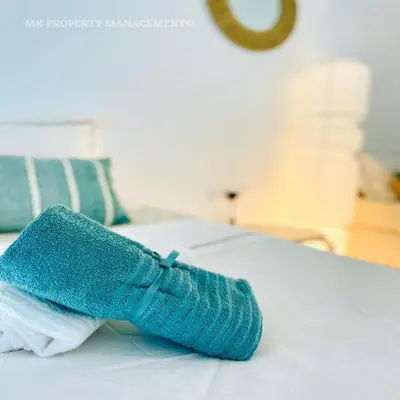 a blue sock sitting on top of a bed at By the Beach Villa 7 in Protaras