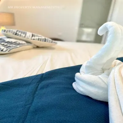 a swan made out of towels on a bed at By the Beach Villa 7 in Protaras