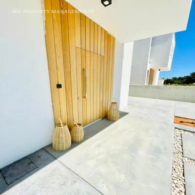three wicker baskets sitting in front of a door at By the Beach Villa 7 in Protaras