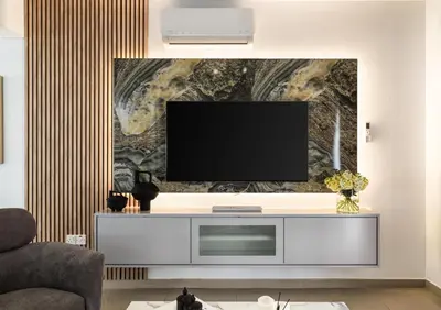 a living room with a flat screen tv on a wall at LuxVillasRentals Ayia Napa in Ayia Napa