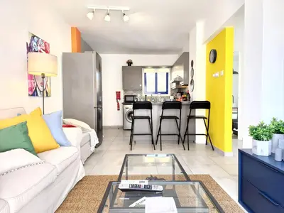 a living room with a white couch and a glass table at Lazuli Frida Two Bedroom Apt in Larnaka