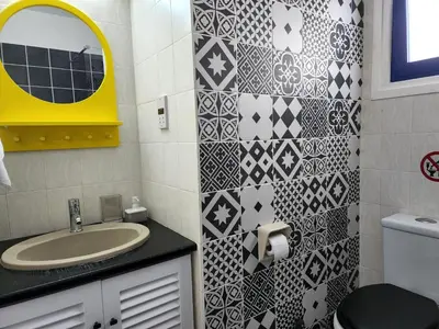 a bathroom with a sink and a yellow mirror at Lazuli Frida Two Bedroom Apt in Larnaka