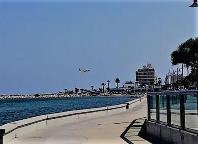 an airplane is flying over a beach with a city at Lazuli Frida Two Bedroom Apt in Larnaka