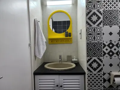 a bathroom with a sink and a yellow mirror at Lazuli Frida Two Bedroom Apt in Larnaka