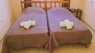 two beds with purple sheets and white towels on them at STAY Chill n' Joy in Ayia Napa