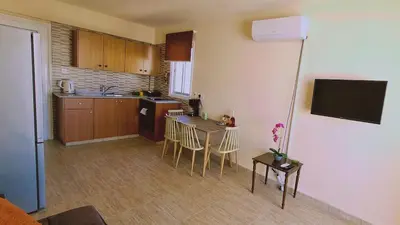 a kitchen with a table and chairs in a room at STAY Chill n' Joy in Ayia Napa