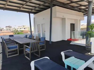 a patio with a table and chairs on a roof at St. Lazaros Studios 2 in Larnaka