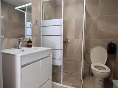 a bathroom with a shower and a toilet and a sink at St. Lazaros Studios 2 in Larnaka
